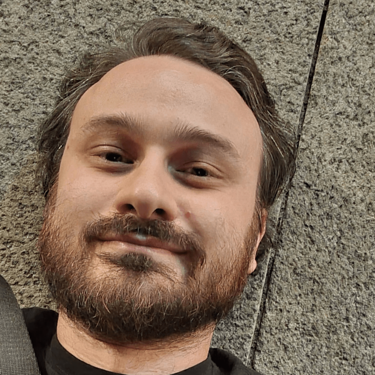 A photo of Mattias Cibien laying on the tiled floor